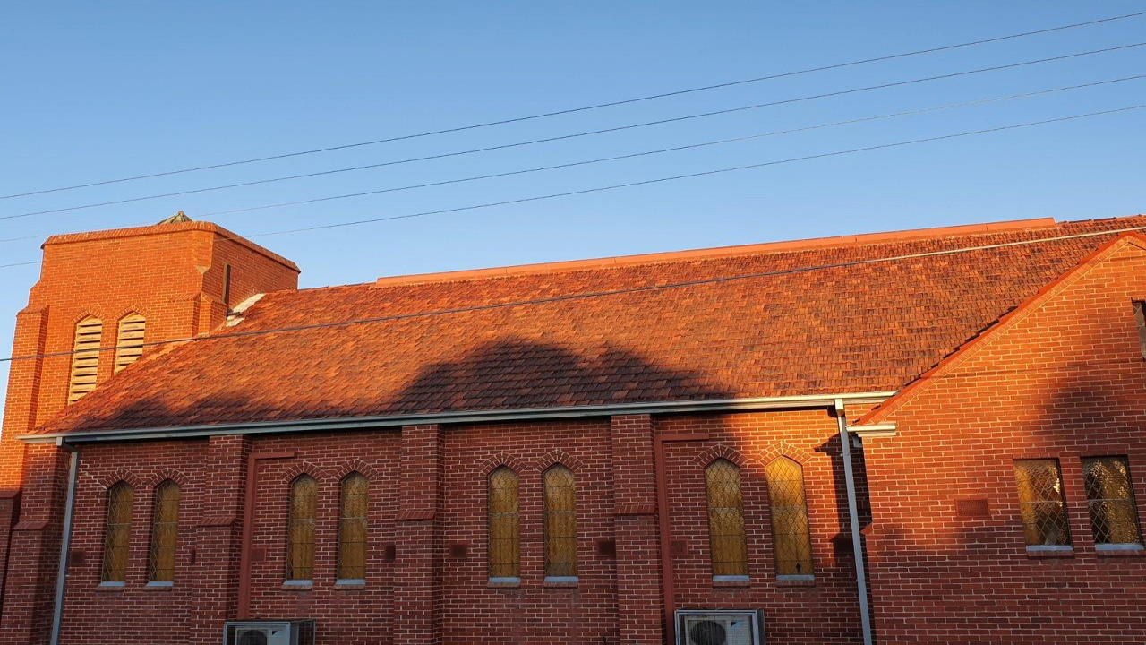Mossy Terracotta Steep Tiled Roof. Image